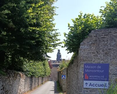 Photo de la rue de Moncontour avec un panneau indiquant l'accueil de la Maison